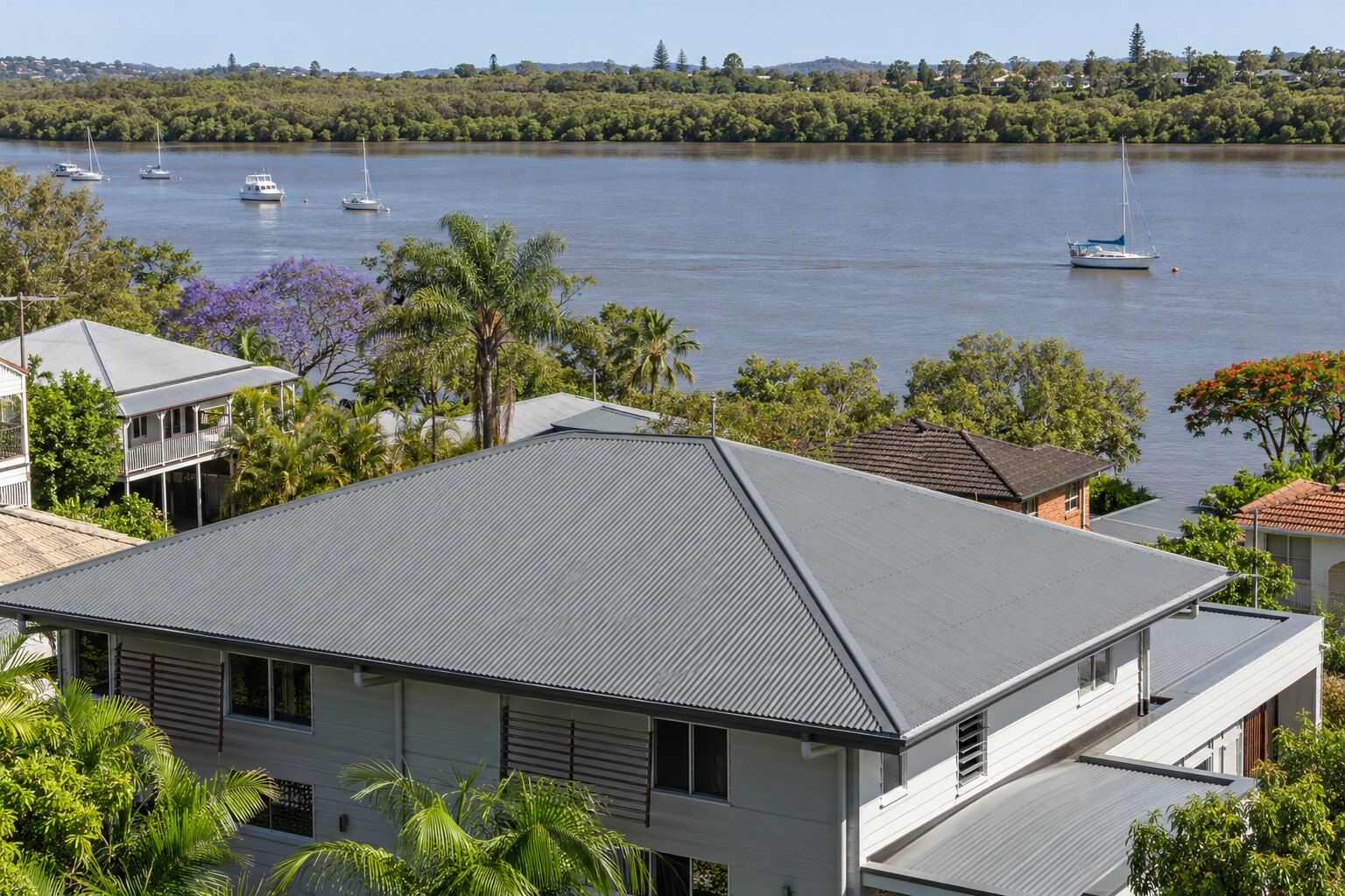 Colorbond roof, Brisbane: grey Colorbond steel roof on a two-storey riverside home beside the tidal Brisbane River